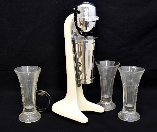 Super 1950s Hamilton Beach Bullet Mixer: 19" tall in classic ivory enamel. Includes its original tin cup and is functional. Includes 3 matching vintage ice cream shake glasses. Shows light signs of use & age.
