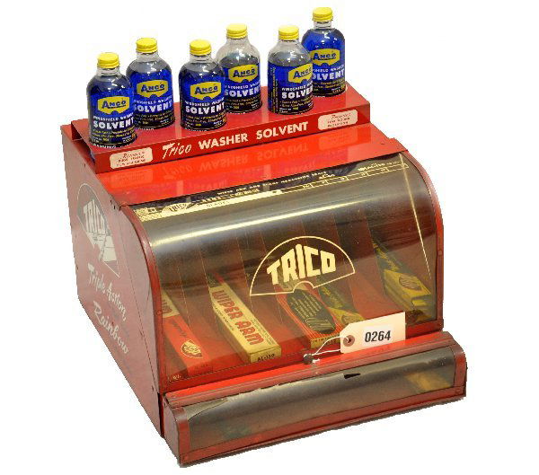 Vintage Trico Wiper Blade Display: 14 X 16 X 11" tin painted cabinet. Top rack holds 6 full Anco washer fluid bottles, inside has a selection of vintage boxed blades. Some damage to lower plastic window, but over-all displays well and