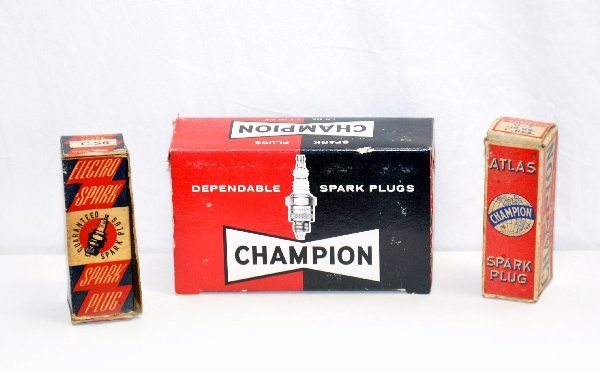 Boxed Vintage Spark Plugs: Case of J-13ys with counter display box, Electro-Spark C56 with box & a Champion Atlas C7 with box. All appear unused, boxes show signs of age. .
