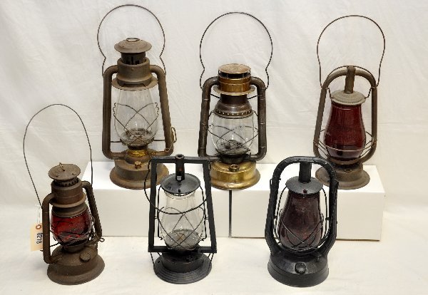 6 Early Oil Lamps: Includes a brass Dietz D-light; 16" CT Ham #2 Cold Blast; Dietz Iron Clad, all with clear globes; Dietz Monarch; Dietz Automatic & Little Wizard with ruby globes. All show signs of use & age. .