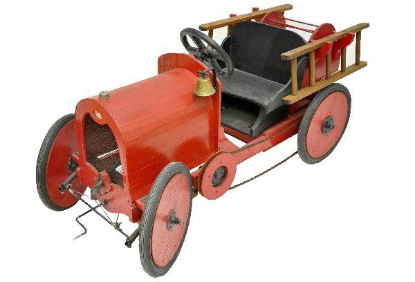 Custom Ford Fire Truck Pedal Car: 64 X 23 X 29", wood & metal construction with brass bell & rubber lined tires. Functions with wide radius turns. Can accept a hose for its reel, has removable ladders and has an adjustable seat. It is