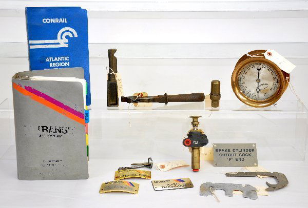 Group of Railroad Parts & Tools: Includes a 6" brass test gauge, by Ashton Valve, Boston; Early electrical reversing handle; GP-38 reversing handle; L-15, GP-38 & EP-20 bell controller; 2- E15 switcher door keys; AAR wheel gauge & de
