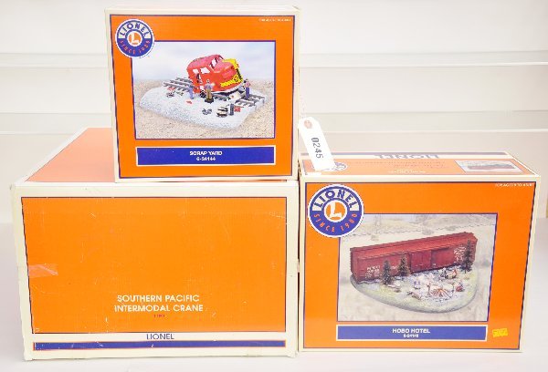 3 Boxed Lionel Accessories: 34144 Scrap Yard; 24149 Hobo Hotel; 22922 SP intermodal crane, all unused, but dusty from display, obs C8-9