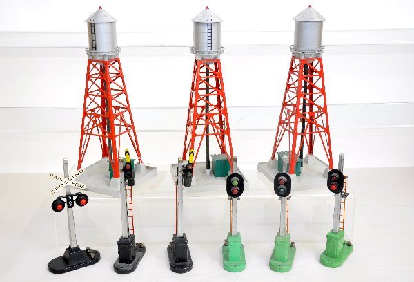 9 Lionel Accessories: 3 #193 water tanks; 3 #153 block signals; 2 #151 semaphores; 154 flasher. All show light to moderate playwear, C6-7