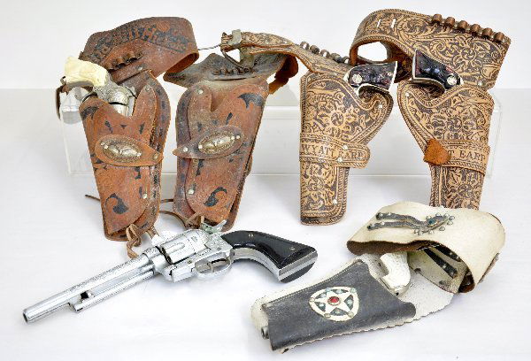 Hubley Cap Gun & Holster Lot: Includes a 45, not working; Rodeo with single holster; Wyatt Earp Double holster set, guns need attention, but clean; Wild Bill Hickok, fictional, but has a broken hammer top in a double holster set.