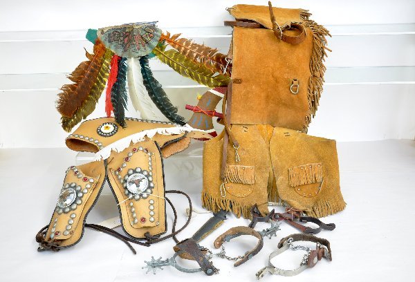 Western Toy & Accessory Lot: Includes a nice leather vest & chaps; jeweled holster set, needs some mending; 2 1/2 pairs of spurs & and Indian head dress with tomahawk. All otherwise show light to moderate playwear. Examine photos