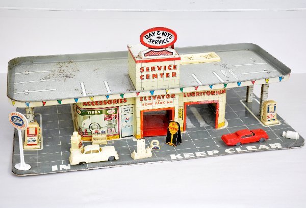 Marx Day & Night Service Center: 26 1/2" wide, litho tin with many accessories, but not complete. Needs a cleaning with a few light rust spots on top. Examine photos or call for more information at 203 730-1404.