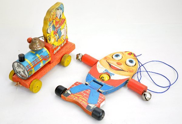 2 Early Fisher Price Toys: Black label 450 Donald Duck Choo Choo. Bell rusty; Scarce 757 Humpty Dumpty, two sided bell toy, price tag tear 1 side, otherwise both show light to moderate playwear, C6-7