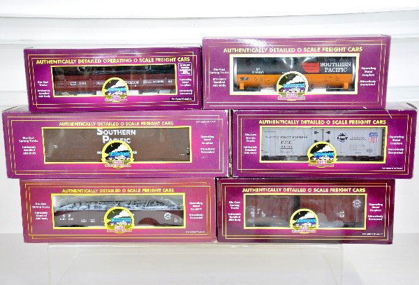 6 MTH Premier SP Freight Cars: 20-97504 wood chip hopper; 90303F boxcar; 98003 gondola with junk; 98721 operating dump car with pipes; 92006 tank car; 94088 reefer. All are like new with boxes, C9