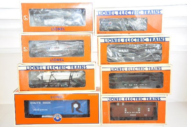 8 Lionel Freight Cars: 16969 flat with airplane; 16968 flat with helicopter; 16661 flat with boat; 16677 flat with submarine; 25026 boxcar; 19813 ice car with load; 17607 smoke caboose with flashing light. All are like new 