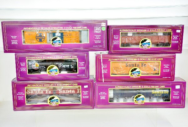 6 MTH SF Freight Cars: 20-94022 operating reefer; 96024 tank car; 98818 flat with pup trailers; 98088 gondola; 96039 TTOS tank car; 97425 center flow hopper, all like new with boxes, C9
