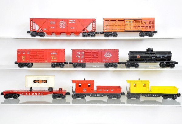 8 Late Lionel Freight Cars: 6130 SF work caboose; 6810 flat with van; 6025 Gulf tank car; 638-2361 Van Camps bank car; 6646 stock car; (6120) work caboose; 6050 Swifts bank car; 6736 D&M quadhopper. All show light to moderate pl