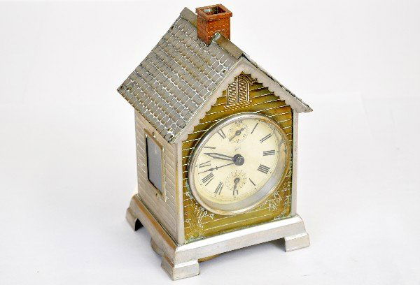 Unusual Seth Thomas Cottage Clock: Circa 1920s. 4 1/2 X 7 1/2" brass & chromed case with paper face & exposed mechanism from side windows. It has both keys with bell alarm, but presently is not working, needs a cleaning. It shows light