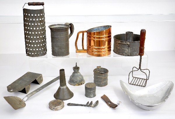 Early Kitchenware Group: Most toll tin ware, including a Swans Down Cake Flour advertising cake mold, copper sifter, match holder; grader, wood handle masher, tankard & other pieces. All show signs of use & age, sifter showin