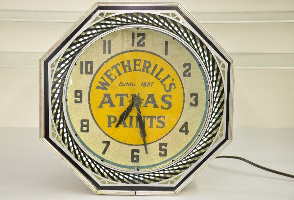 Scarce Wetherill's Paint Neon Motion Clock: 18" octagonal shaped deco clock with glass face. Advertising Atlas Paints. It has a white neon outer ring under a motion ring. Clock, light & motion function, but glass has a crack and was repaired at