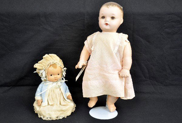 Two Composition Dolls: Ideals Baby Coos, 18", sleep eyes with mama sound, cloth body with compo arms, some light crazing, has vintage dress; 8 1/2" sitting compo doll, unmarked with much crazing & a 3" repair on painted hai