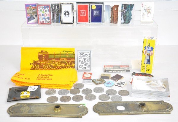 Railroad Group: Includes 2 brass C&NW Doorknob escutcheons; Several math books and packs from various railways; Playing cards include, 1978 TCA; C&NW, NPR Double pack; IC, Amtrak & others. EMD 1983 coins. 2 #1969 Fly