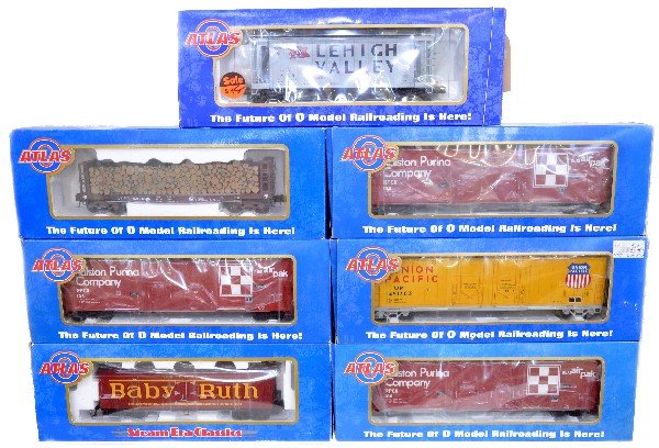 7 Atlas Freight Cars: 6352-2 hopper; 6703-1 reefer; 2 #6504-1 boxcars; 6401-1 tank car; 6506-2 boxcar; 6274-2 pulpwood flat. All appear like new with boxes, C9