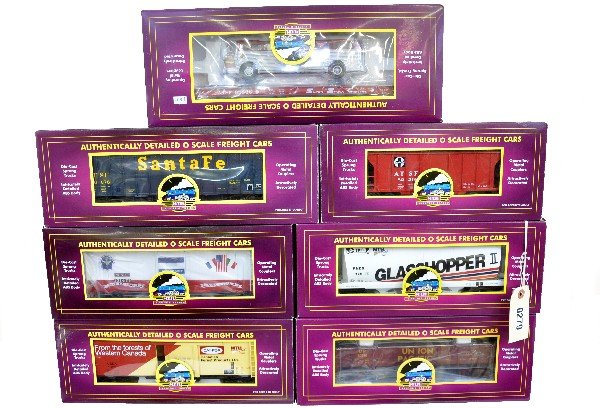 7 MTH Freight Cars: 20-97442 cylindrical hopper; 90013E hopper; 97485 hopper; 98832 flat with bus; 94028 reefer; 98094 drop bottom gondola; 93524 boxcar. All are like new with boxes, C9