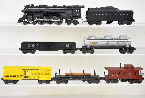 7 Pc Lionel Steam Freight Set: 2056 Hudson loco; 2046W tender, 1 broken step; 6415 tank car; 6656 stock car, small nick in catwalk; 6462 gondola; 3461 log dump, light rust spots; 6457 caboose. All need a cleaning and show moderate 