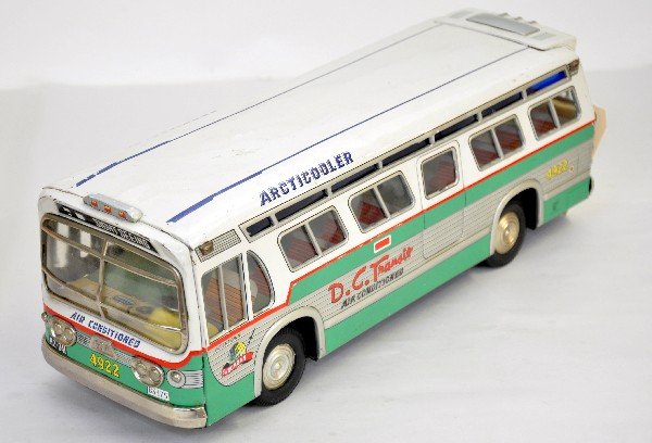 Large Japanese Tin Bus: ATC Japan. 17" long, litho tin friction with fantastic graphics GM model marked D.C. Transit. Dual rear rubber wheels, just missing clear rear window insert. Shows light playwear and is a scarce toy, 