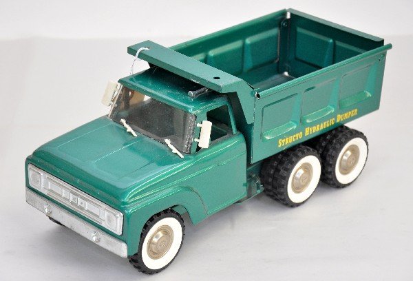 Deluxe Structo Hydraulic Dump Truck: Pressed steel, 14" long. Circa 1962 with all the deluxe trim & white wall tires, mechanism is functional. Truck is clean & shiny & shows light playwear, C8