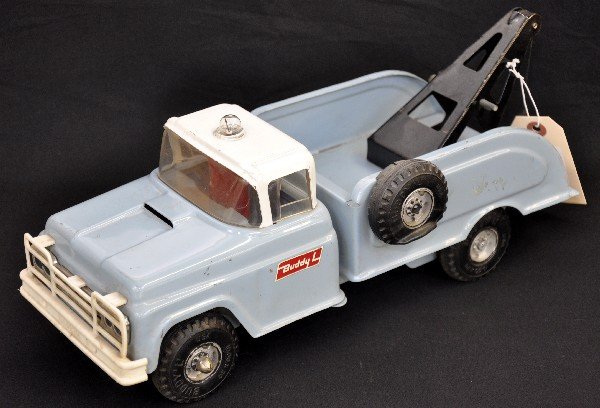 Deluxe Buddy L Wrecker: Circa 1962, pressed steel with battery light, 14" long. Has removable front tire & flat spare, red light cap not shown in photo. It has its original hook & line and shows light playwear, C7+