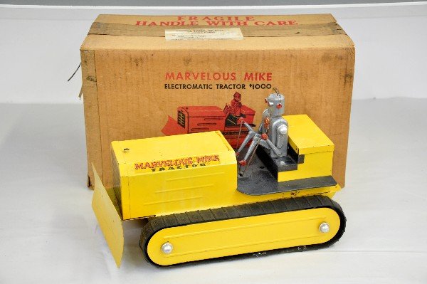 Boxed Saunders Marvelous Mike Tractor: Pressed steel with rubber treads, 14" long. Battery mystery action with animated robot driver functional at time of test, but needs lubrication, not guaranteed. Treads have been repaired and battery b