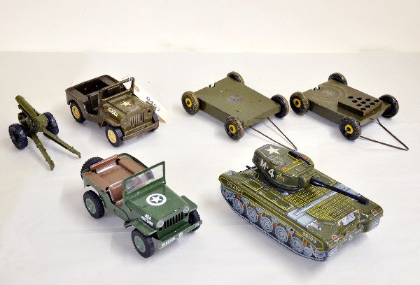 6 Pc Tin Military Toys Lot: Includes a TN Japan 8 1/2" Tin M4 friction tank; Czech Republic Sites Jeep; Plastic Howitzer; small size Tonka Jeep (C5); 2 incomplete Marx trailers, otherwise show moderate playwear, C5-8. Examine ph