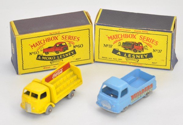 2 Boxed Early Matchbox Vehicles: 60 Morris Pick-up, silver plastic wheels with red/white decals, axel oxidation; 37 Coca-Cola truck, gray plastic wheels, minor edge wear on rear decal. Both have nice obs, otherwise C9
