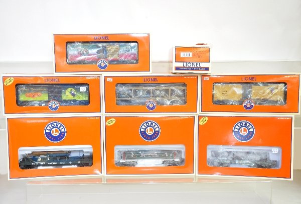 8 Boxed Lionel Freight Cars: 26836 Halloween car with sounds; 26858 boxcar with Christmas music; 29464 Army vat car; 36770 ice car; 18489 rail bonder; 26825 & 29806 log dump cars; 26870 coal dump car. All show light playwear with