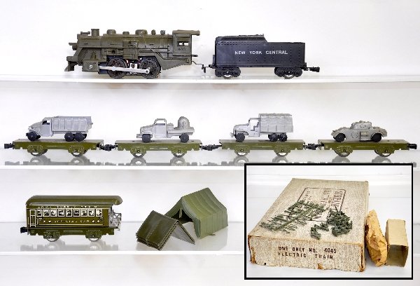 Boxed Marx Military Set 4045: 400 Khaki steam loco; black NYC tender; flat w/open stake truck; flat w/armored car; flat w/searchlight truck, cracked window strut; flat w/covered truck; official car obsv w/sleeve; 356-6 Soldiers in