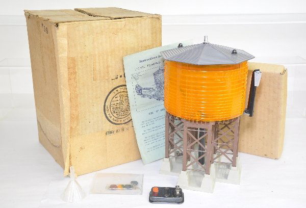 Boxed Lionel 38 Pumping Water Tower: Clean and complete with original instructions, controller, finial, funnel and RARE color dye pellets still in cellophane. Worn box has taped over label with 2 inserts. Tank shows light to moderate pla