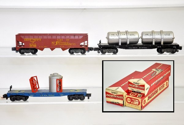 3 Boxed American Flyer Freight Cars: S Gauge. 24575 rocket fuel flat, missing 1 container, unmarked cardboard ob; 24572 jet engine transport, each container missing 2 stakes; 24216 UP hopper. All will clean nicely & otherwise show light 