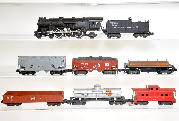 7Pc American Flyer 293 Freight Set: S Gauge. Late 293 NYNH&H Pacific with coal pusher; 924 JC Cement car; 9421 Frisco gondola; 921 CB&Q hopper; 914 Log dump car with load; 925 Gulf Tank; 938 caboose. All show moderate playwear & should 