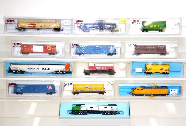 13Pc Boxed Atlas N Gauge Diesel Freight Group: Includes a UP FN "C" diesel; BN E7, box missing top and 11 assorted freight cars. All otherwise appear LN to near mint with boxes, C8+-9