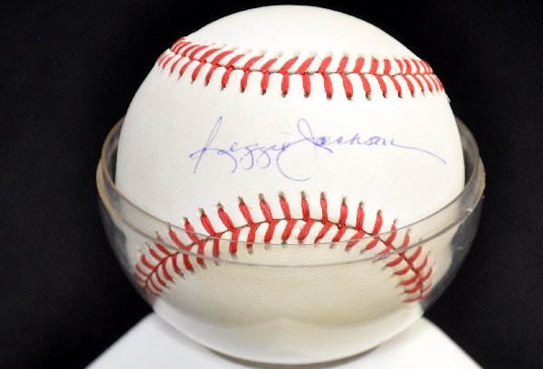 Super Signed Reggie Jackson Baseball: Circa 1970s; Rawlings ball, clean signature in blue pen in the sweet spot. The ball is clean and has a plastic holder. Examine photos or call for more information (203) 730-1404.