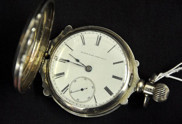 Unusual Heavy Case Elgin Pocket Watch: Coin silver case #58203 with horse design. 2 3/4" porcelain face. Movement #1978216 and is functional. Examine photos or call for more information, (203) 730-1404.