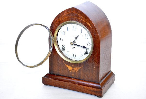 Seth Thomas Mantel Clock: 11" dome mahogany case with inlay. Porcelain face with pierced hands. Functional at time of test, but time accuracy is not guaranteed. Case shows light signs of use with nice patina. Examine photos or