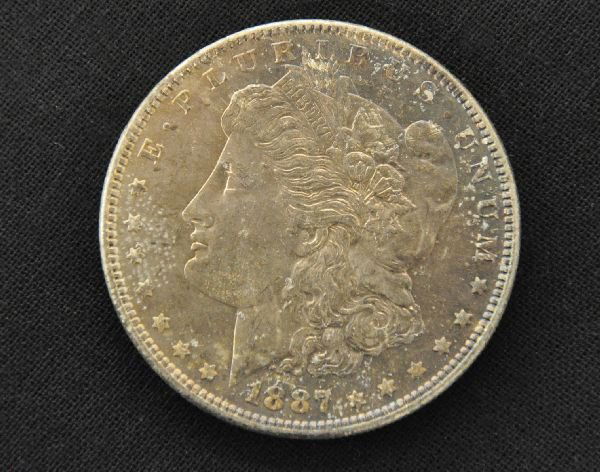 1887 Morgan Silver Dollar: MS62 with even toning. Grades are our opinion, so examine photos closely, or call for more information, 203 730-1404.