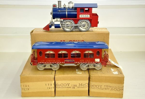 5Pc McCoy TTOS Passenger Set: ST. GA. Circa 1979. Includes an 0-4-0 steam tank loco with dent in coal bunker, plus 4 matching day coaches in boxes. Cars are like new, C9