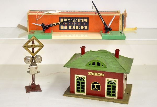 2 Lionel Accessories: Includes a 126 station; 47 crossing gate missing lanterns with rough box & 69 warning signal. All are dirty and show moderate playwear. They should clean to C6
