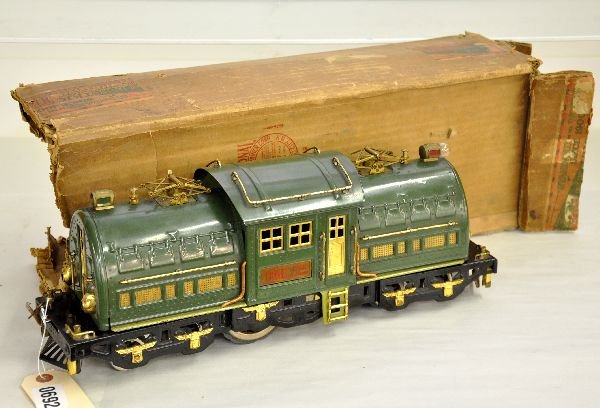 Boxed Lionel 381E Electric: Original owner lot. ST. GA. Top of the line for 1929. Clean with fatigued drivers, missing 1 pair & axle. Pony wheels need springs and 3 screws. One hood shows moderate scratches, and missing 1 couple