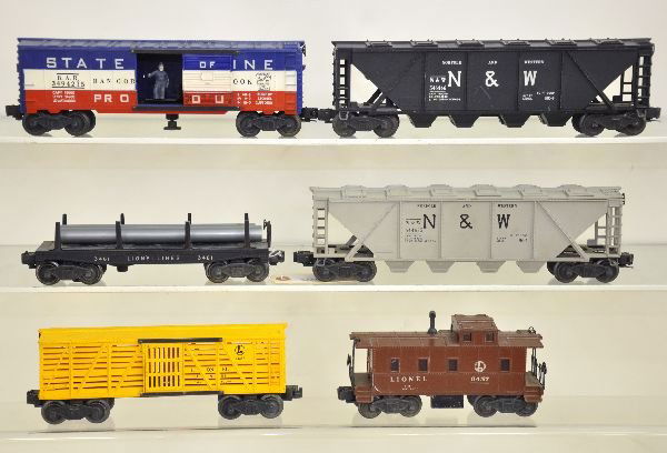 6 Lionel Freight Cars: 3461 lumber dump; 6446-54 N&W quadhopper; 6446-25 N&W quadhopper; 6656 stock car; 6457 caboose; 3494-275 SOM Oper boxcar. All show light to moderate playwear and should clean to C6+-7