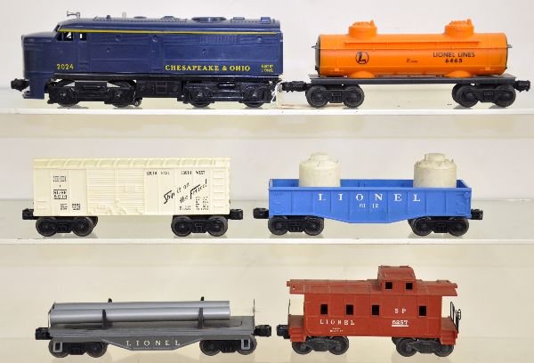 6Pc Lionel Diesel Freight Set: 2024 C&O Alco A Diesel, intact cowl; 6465 tank car; 6014 boxcar; 6112 gondola with 2 canisters; 6121 flat with pipes; 6257 caboose. All show light to moderate playwear, C7
