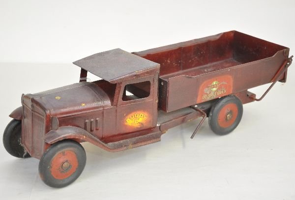 Early Buddy L Dump Truck: Circa 1920s. 20" long with International styling. It had been repainted a long time ago. Nice as-is or for restoration.