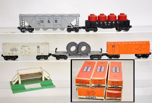 5 Boxed Lionel Freight Cars: 6446-54 N&W quadhopper, some corrosion on trucks; 3472 milk car & platform, cans inside, platform top rusty; 6004 boxcar; 6112 gondola with canisters, all have boxes; 6561 flat with reels. Trains show