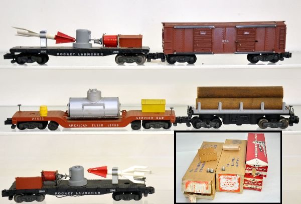5 American Flyer Freight Cars, Most Boxed: S Gauge. 2 #25045 rocket launchers, loose one has broken rocket, 1 insert; 24533 track cleaner; 974 operating merchandise car with 5pc load & wrap; 914 log unloading car. All otherwise show light to m