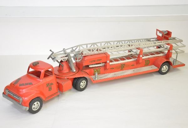 1955 Tonka Aerial Fire Ladder Truck: Decaled MFD makes this the first fendered fire truck. It is unusually clean for an original owner toy, with a satin, unpolished patina. It is complete, save for the coupling plate on the tractor. The 