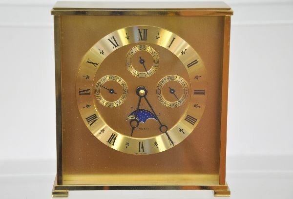 Brass 4-Dial Tiffany Alarm Clock: 7X2 1/2X7" solid brass with day/date dials & animated day/night window. Functions, marked Tiffany Co. made in Germany. Very nice condition, shows very light signs of use. Examine photos or call for mo